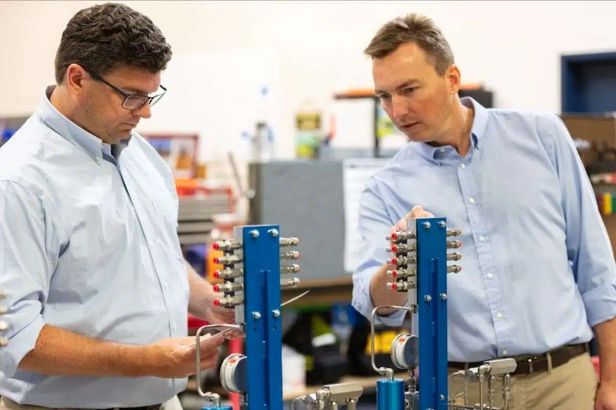 c8664f38-0c43-74f5-067a-0e72efff0b55 (1) CJ and Eric Sloan, examining some custom lubrication systems that are ready to ship