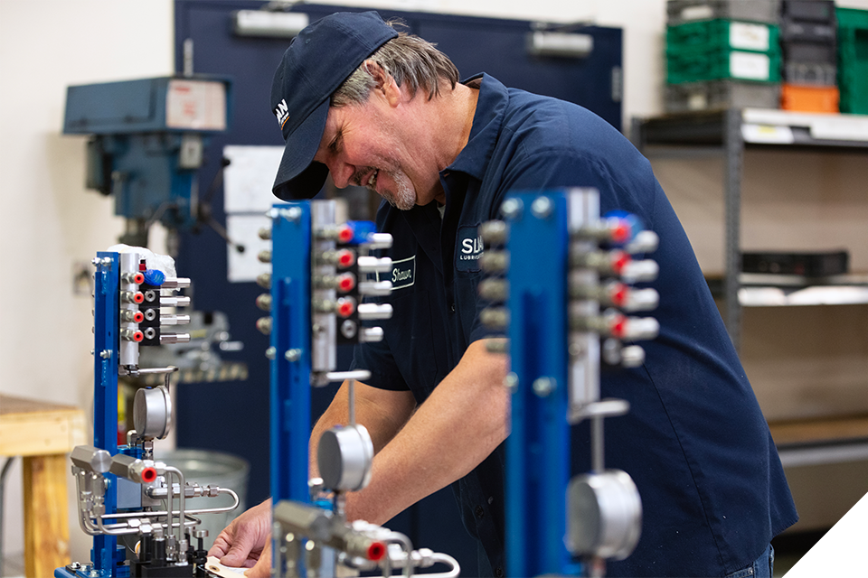 Sloan Lubrication Systems employee working on some custom lubricator boxes